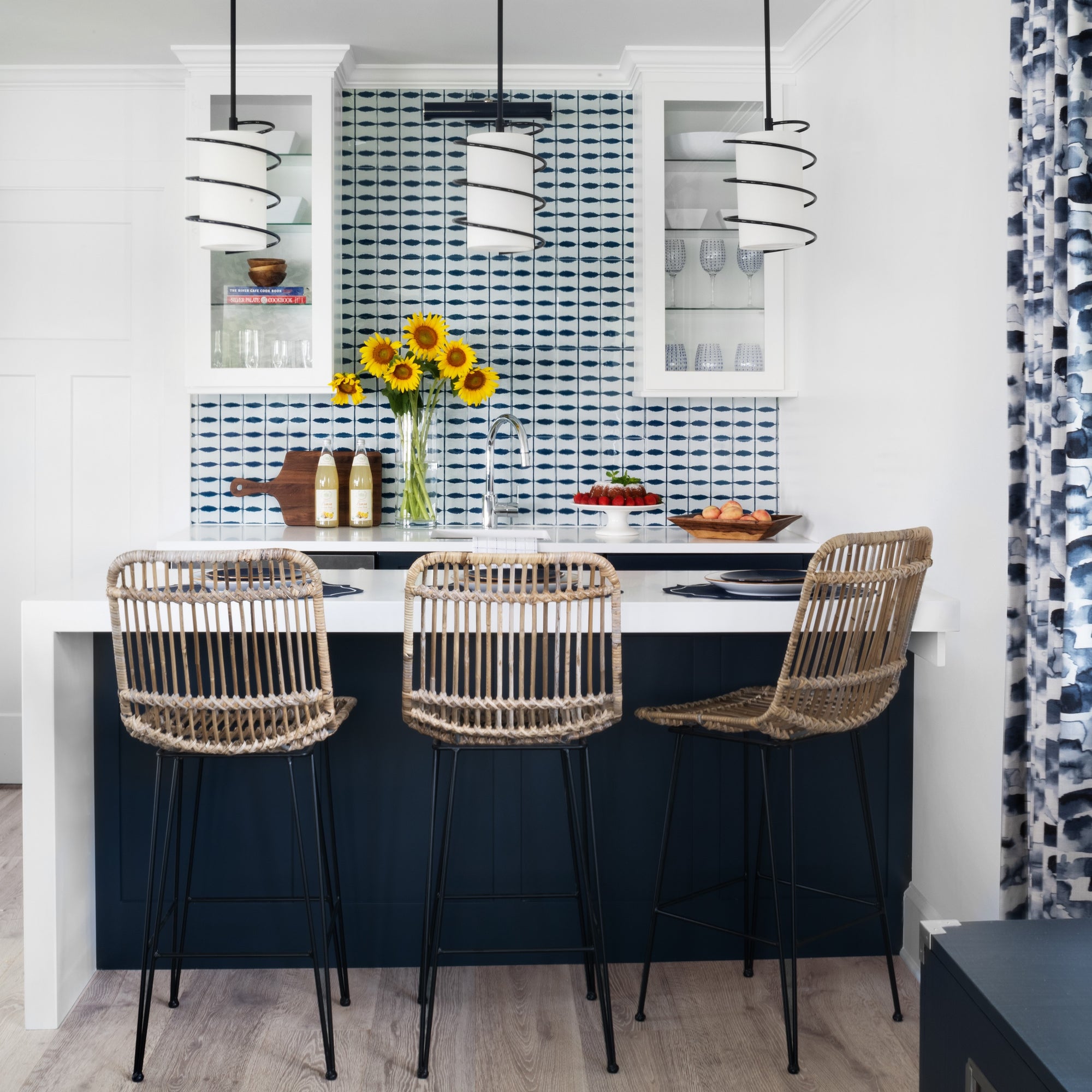 Kitchenette with blue and white backsplash tile and contemporary pendant lights. Guest cottage designed by Jamie Merida.