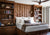 Bed with custom platform, headboard, and bookcases made with rich exotic woods. Designed by Jamie Merida.