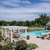 Poolside pergola, outdoor dining area, and lounge chairs