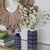 Home Accents at Bountiful Home - blue and white ceramic vases in front of a wooden sunburst mirror